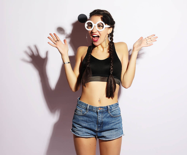 Attractive surprised young woman wearing creative sunglasses, be - Фото, изображение