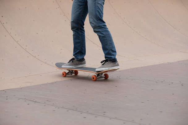 Cropped image of skateboarder sakteboarding on skatepark ramp - Photo, Image