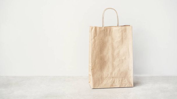 Brown paper bag on the floor - Фото, изображение