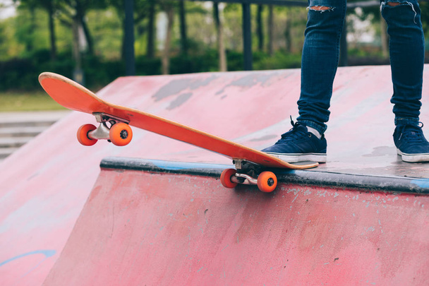 Cropped image of skateboarder sakteboarding on skatepark ramp - 写真・画像