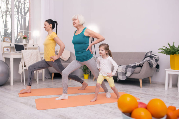 Happy sporty family exercising together - Photo, Image