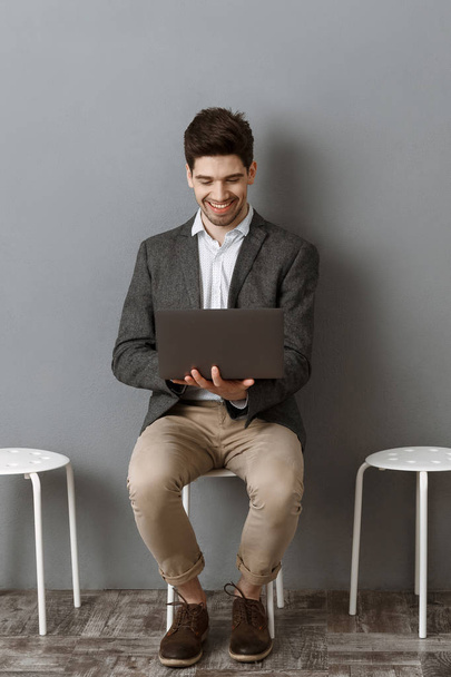 homme d'affaires souriant utilisant un ordinateur portable en attendant l'entrevue d'emploi
 - Photo, image