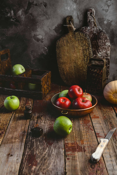 grater, cutting boards, pumpkin, plate with apples and knife on wooden table  - Foto, immagini