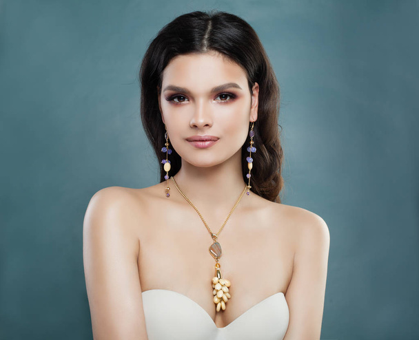 Cheerful Brunette Woman with Gem Earrings and Necklace. - Fotoğraf, Görsel