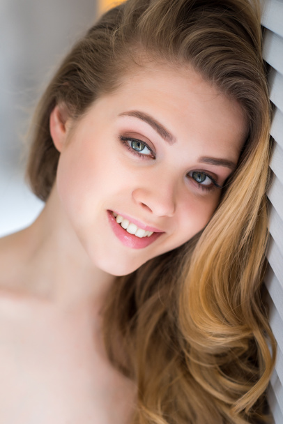 portrait of smiling blonde girl looking at camera - Photo, Image