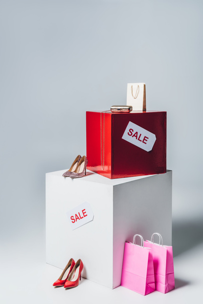 high heels, pink shopping bags and sale signs, summer sale concept - Fotó, kép