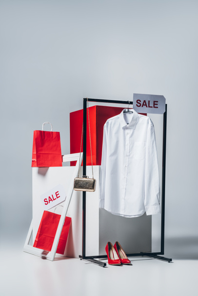 shirt on hanger, shopping bags and sale signs, summer sale concept - Zdjęcie, obraz