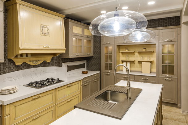 Stylish kitchen with chandelier over modern sink - Zdjęcie, obraz