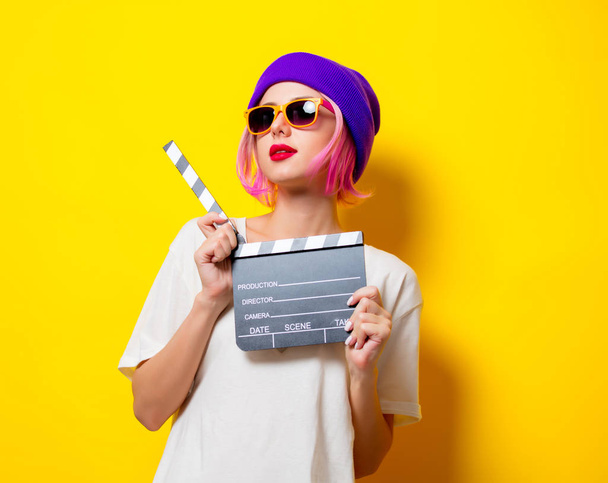 girl with pink hair holding movie clapper - Фото, изображение