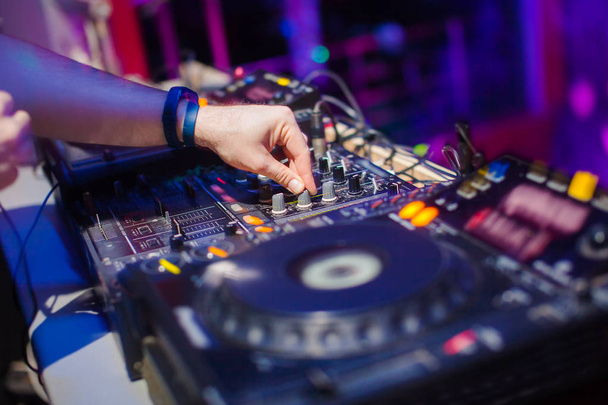 DJ mixing music on console at the night club - Photo, image