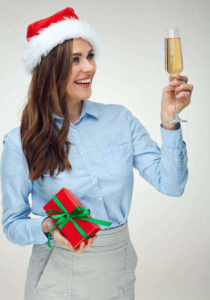 Businesswoman wearing Christmas hat holding shampagne glass.  - Zdjęcie, obraz