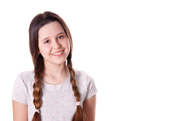 Portrait of the young smiling girl over the white background - Фото, изображение