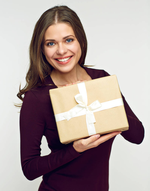 Happy woman  wearing brown dress holding gift box - Fotoğraf, Görsel