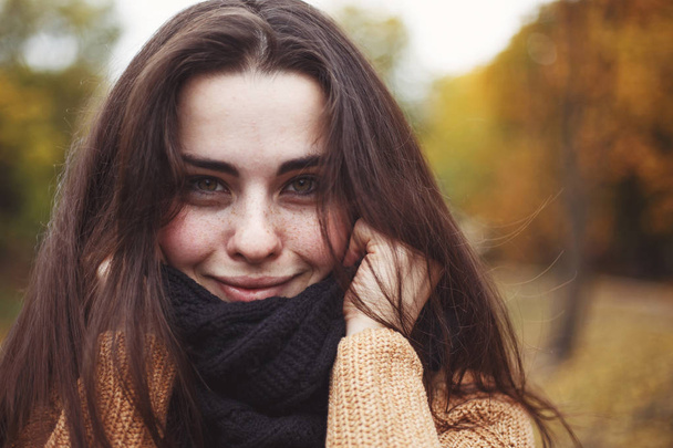 Close up portrait of young pretty smiling woman wearing knitted  - Photo, image