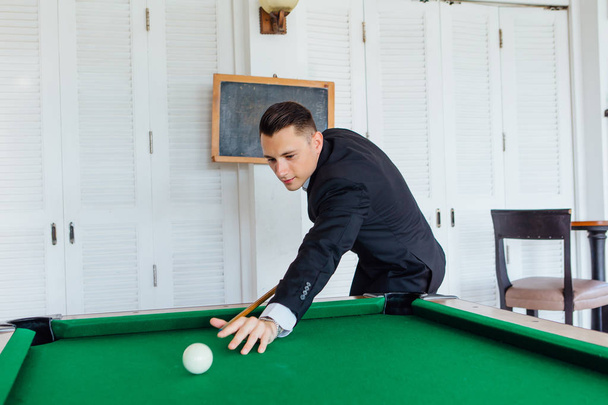 Young handsome man playing billiard game alone - Zdjęcie, obraz