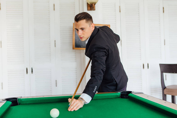 Young handsome man playing billiard game alone - Photo, image