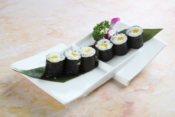 Closeup of plate with sushi roll on table - 写真・画像