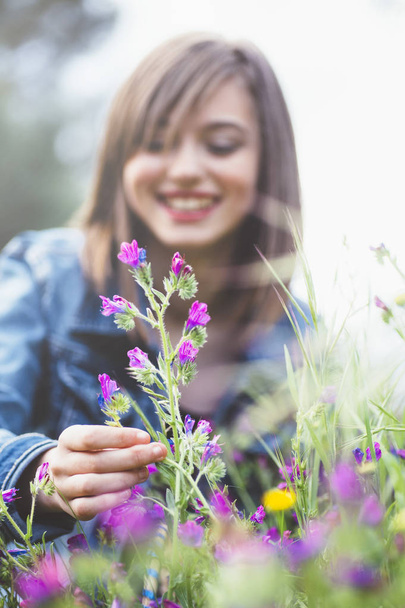 Happy teen girl in the forest with flowers - Photo, Image