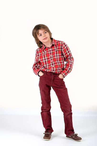 The boy in a red shirt in a section and in velveteen jeans stand - Photo, image