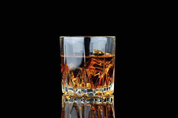 Whiskey with ice isolated on a black background. - Φωτογραφία, εικόνα