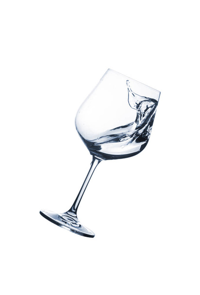 Water splash in glasses isolated on white background. Beverage with splash. - 写真・画像