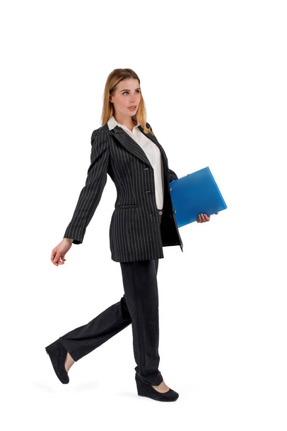 The young attractive woman in a business suit goes and holds the - Φωτογραφία, εικόνα