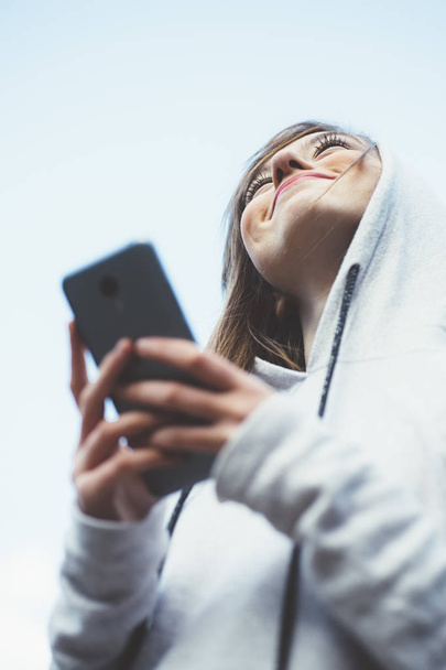 Portrait of teenage girl with sports clothes and smartphone - Photo, Image
