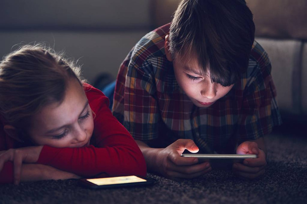Girl and boy with their smart phones - Фото, зображення