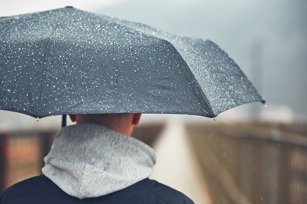 Man with umbrella in rain - Photo, image
