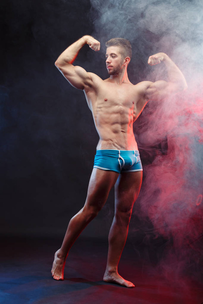 Young muscular ripped man bodybuilder with perfect body posing o - Φωτογραφία, εικόνα