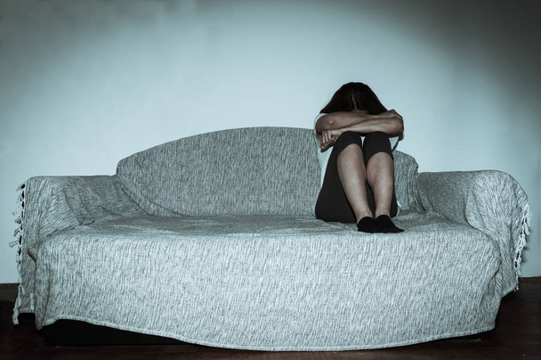 Lonely sad and depressed girl abused as young is alone in her dark room and cry - Fotoğraf, Görsel