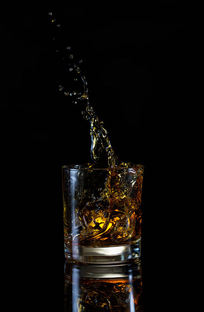 High splash in glass of whiskey - Photo, Image