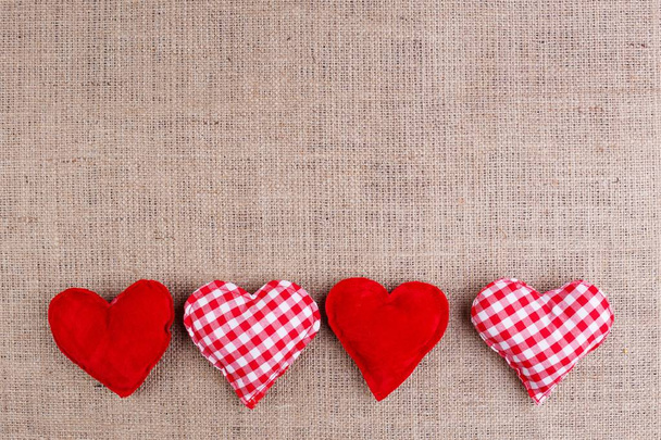 Valentines Day background with fabric hearts on sackcloth, copy  - Zdjęcie, obraz