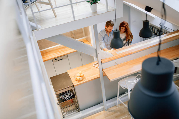 Beautiful couple posing in well designed kitchen - Foto, afbeelding