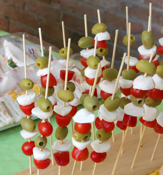 Caprese skewers with tomato mozzarella green olives and many san - Photo, Image