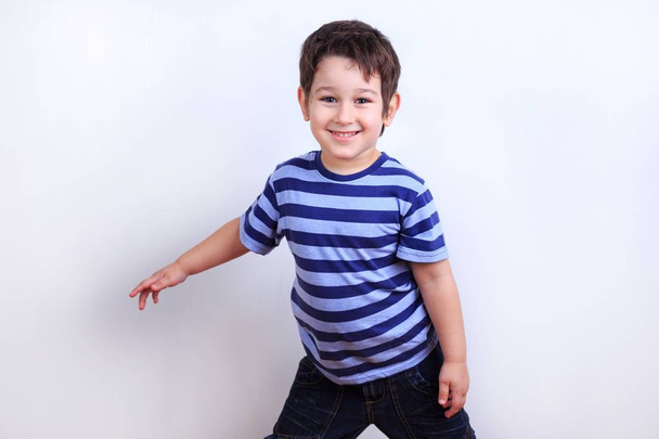 Little lovely boy smiling and posing, studio shoot on white. Emo - Photo, Image
