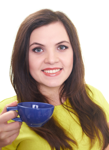 Attractive smiling young woman in a yellow shirt holding a blue - Fotografie, Obrázek