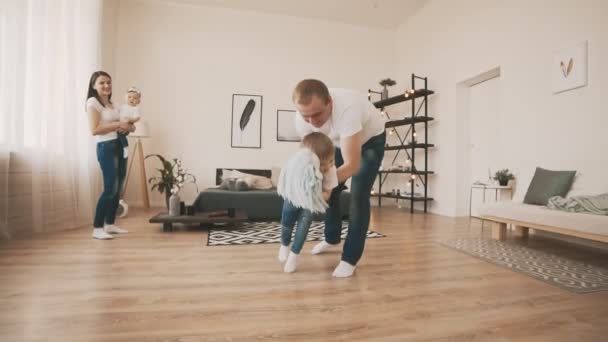 Young Father and Little Son have fun at home with toy horse in slow motion - Materiał filmowy, wideo