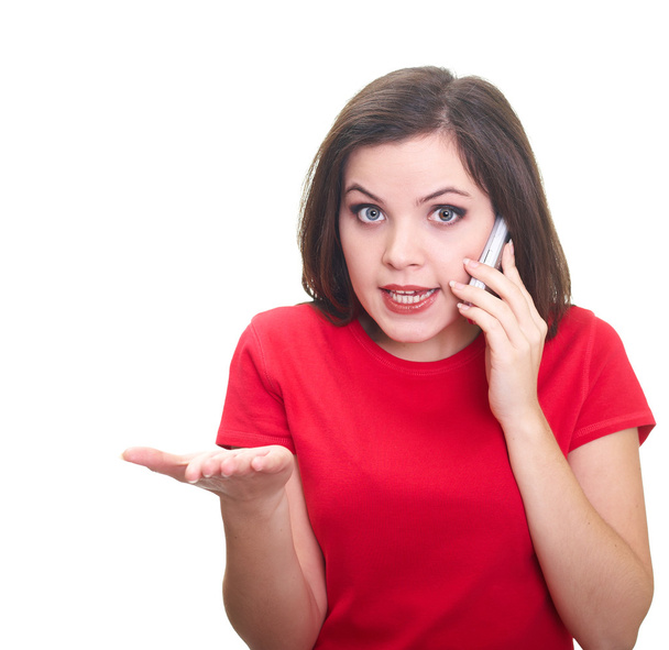 Attractive young woman in a red shirt talking on a mobile phone - Фото, изображение