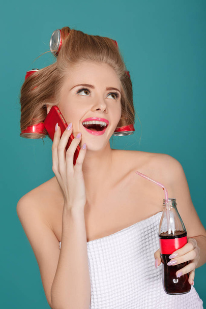 blond woman holding glass bottle with soda - 写真・画像