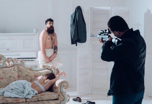 Man at gunpoint of killer. Husband found lovers, killed wife and threatening to bearded lover. Man with beard naked, scared, shocked at gunpoint, interior background. Cheating and jealousy concept. - Fotoğraf, Görsel