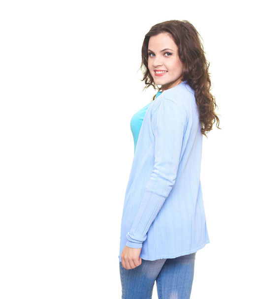 Happy smiling young woman in a blue shirt turned back. - Photo, image