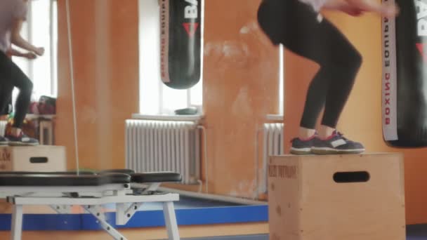Vrouw kickbokser is opleiding in een sportstudio met halters - Video