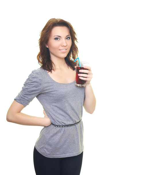 Attractive young woman in a gray T-shirt holding a glass of drin - Foto, Bild