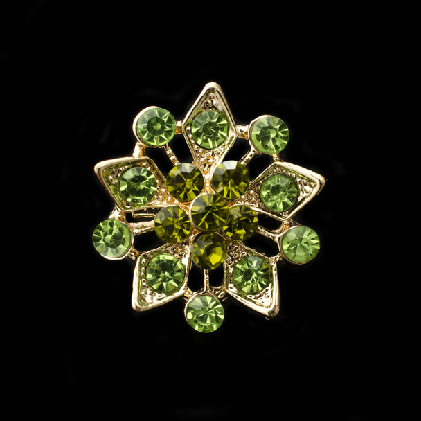 broche de ouro com esmeraldas isoladas em preto
 - Foto, Imagem