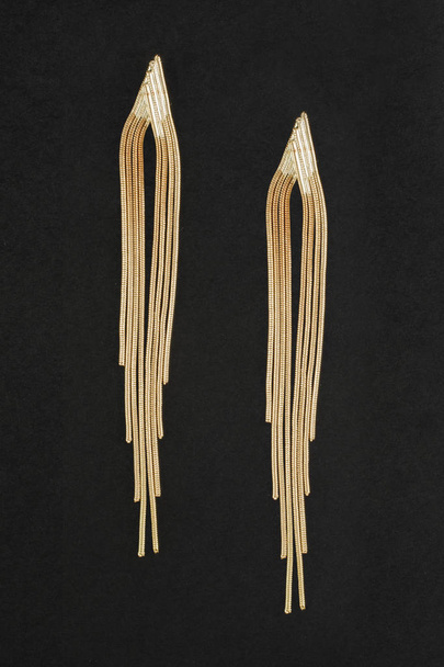 gold chain earrings isolated on black - Foto, Imagen