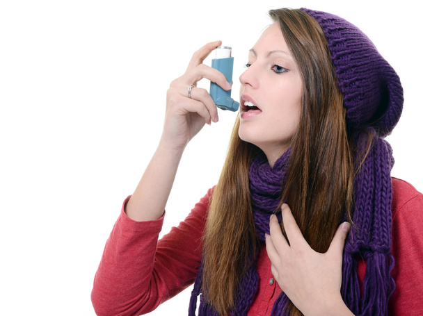 Woman with asthma using an asthma inhaler - 写真・画像