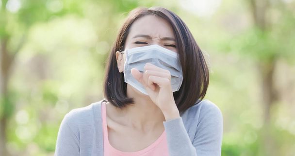 woman got sick and coughing  in the forest - 写真・画像