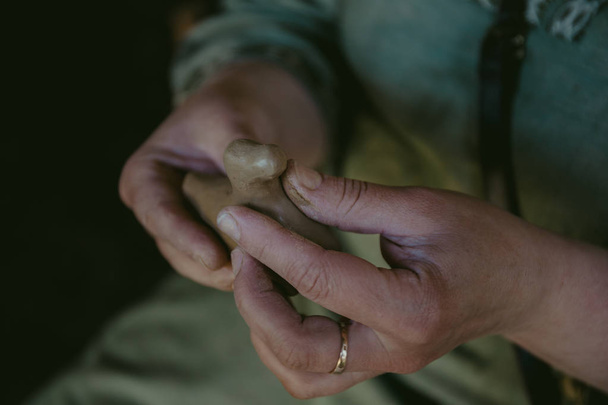 Potter works with clay, craftsman hands close up, kneads and moistens clay - Foto, Imagem