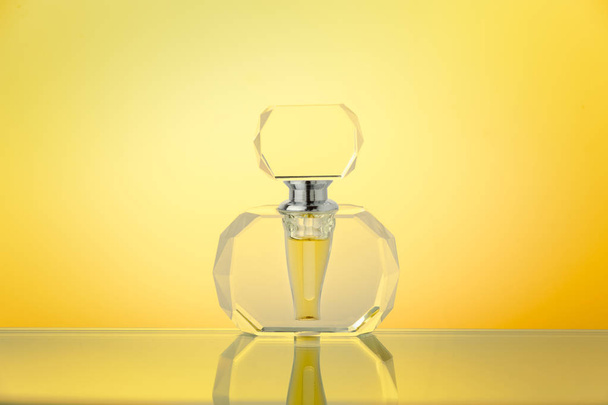 Crystal bottle on yellow gradient background - 写真・画像